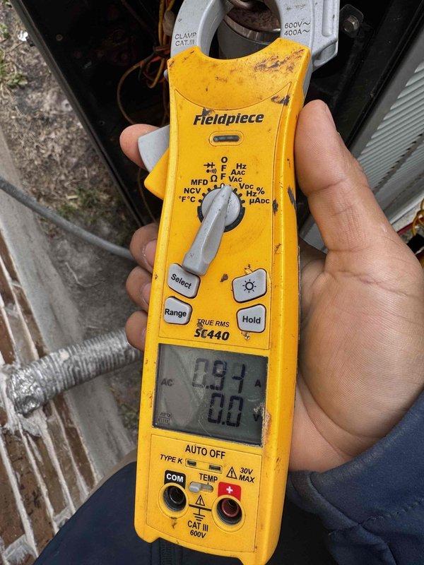Performed spring maintenance service on a 10-year-old HVAC system located in the attic. Conducted electrical diagnostics using clamp meter, detecting normal amperage readings of 0.91A. Inspected and verified proper installation of flexible ductwork connections to the air handler unit.