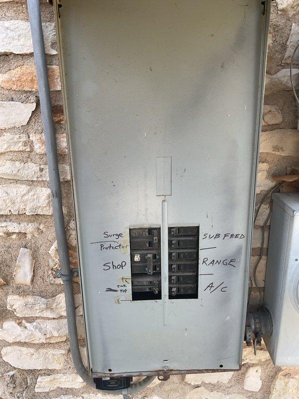 Conducted comprehensive electrical maintenance service on a 48-year-old residence with two breaker boxes located in the garage and laundry room. Performed thorough inspection of electrical panels, including main distribution panel mounted on stone wall and digital Pedernales Electric Coop meter. Completed system tune-up with verification of circuit labeling and operational status of all breakers.