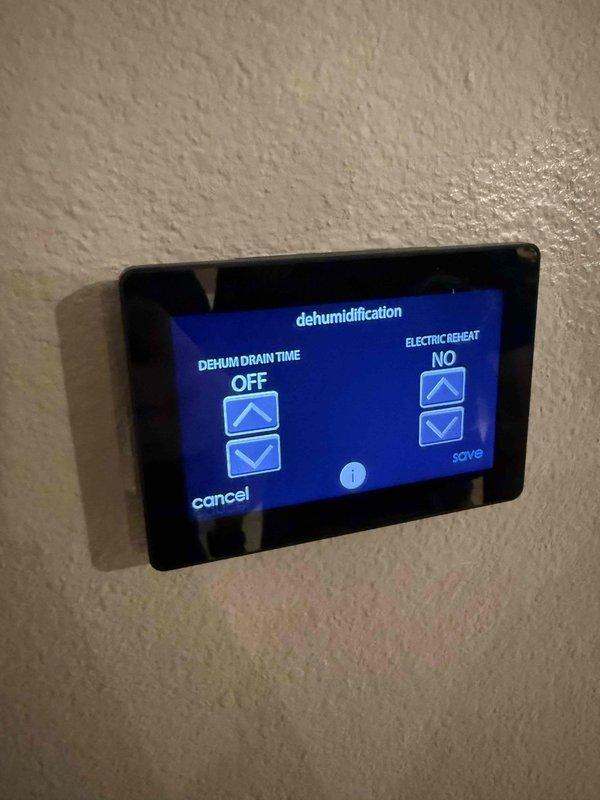 Responded to no cooling complaint on 2-year-old system with recurring error code 44 on thermostat. Performed diagnostic evaluation of attic-located air handler and associated components. Inspected dehumidification control settings on digital thermostat interface and verified electric reheat configuration. Examined internal air handler components including refrigerant lines, electrical connections, and wiring harness for proper operation. Documented system conditions with photographic evidence showing control panel settings and internal unit components for further technical review.