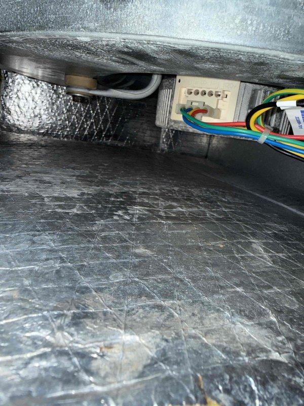Responded to no cooling complaint on 2-year-old system with recurring error code 44 on thermostat. Performed diagnostic evaluation of attic-located air handler and associated components. Inspected dehumidification control settings on digital thermostat interface and verified electric reheat configuration. Examined internal air handler components including refrigerant lines, electrical connections, and wiring harness for proper operation. Documented system conditions with photographic evidence showing control panel settings and internal unit components for further technical review.