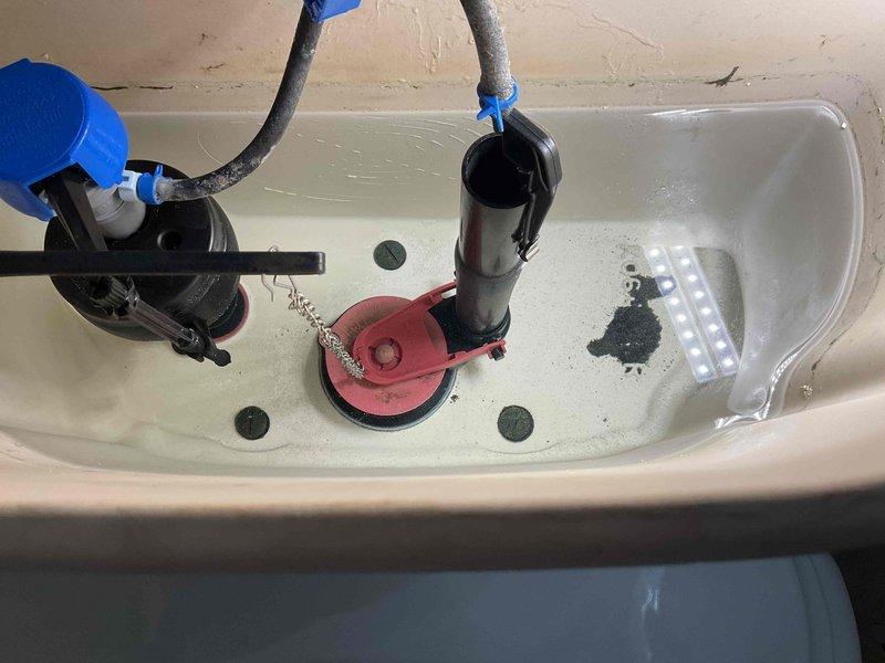 Completed comprehensive plumbing maintenance inspection on 1996 residential property. Evaluated electric tank-style water heater located in attic, documented water softener system and associated equipment in utility area, and performed toilet tank inspection including assessment of flush valve, float mechanisms, and internal components. All systems inspected and photographed for maintenance records.