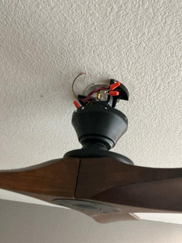 Responded to a non-operational bedroom ceiling fan that would not turn on from the wall switch. Upon inspection, discovered faulty wiring connections at the ceiling fan mounting bracket. Disconnected power at the breaker, removed the fan canopy, and found loose and improperly terminated wire connections at the junction box. Re-stripped and properly secured all electrical connections using approved wire connectors, ensuring proper contact between line voltage wires and fan leads. Verified secure mounting of the fan to the existing ceiling box and bracing system. Restored power and tested fan operation through all speed settings and light functions from the wall control panel, confirming full functionality. System now operates as intended with all controls responding properly.