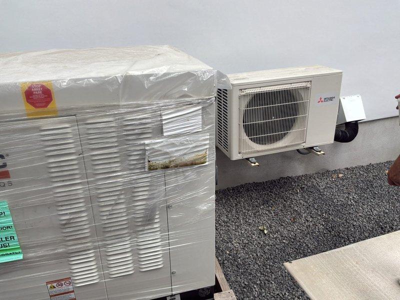 Provided quote for relocation of existing 1.5-year-old Mitsubishi mini-split outdoor condenser unit to accommodate upcoming generator installation and ensure code compliance. Assessed current rooftop installation location, measured required relocation distance, and evaluated line set extension requirements, electrical disconnect repositioning, and refrigerant line modifications needed to safely move unit several feet from its present location. Documented existing equipment condition and installation setup to determine scope of work for relocation project that will maintain system integrity while meeting electrical code clearance requirements for new generator placement.