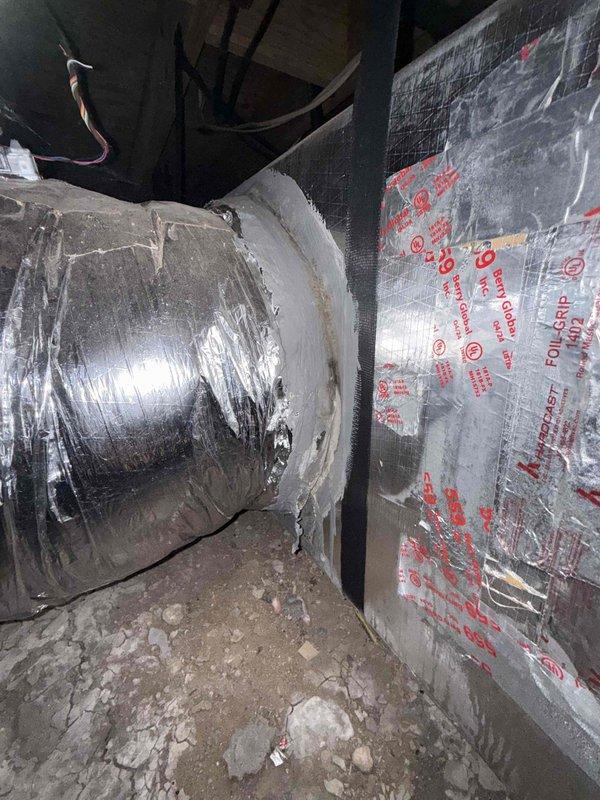 Completed spring member maintenance on a dual-zone HVAC system with under-house crawl space air handler installation. Performed comprehensive system inspection including verification of Zone 2 operation following previous service call that identified non-functional zone damper and significant ductwork leakage. Inspected exterior disconnect box, condenser unit, and crawl space air handler with associated ductwork and insulation; documented system condition with photos showing reflective foil-wrapped supply ductwork and rigid foam board insulation in crawl space area. System confirmed operational with both zones functioning properly at time of service completion.