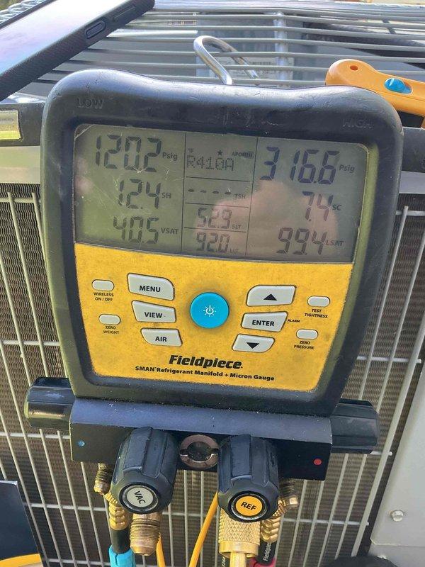 Completed comprehensive preventive maintenance tune-up on a single-zone residential HVAC system located in attic installation. Performed complete system diagnostics including refrigerant pressure testing using dual-port manometer, measuring static pressures at 0.12" and 0.36" on supply and return sides. Utilized refrigerant manifold gauge to verify system charge levels, recording high-side pressure at 316.6 psig with 74°F temperature and low-side pressure at 120.2 psig with 124°F temperature. All refrigerant pressures and temperatures within manufacturer specifications for proper system operation. Inspected condensing unit, evaporator coil, and all accessible refrigerant lines for leaks, damage, or deterioration. System operating efficiently with no deficiencies noted during diagnostic testing.