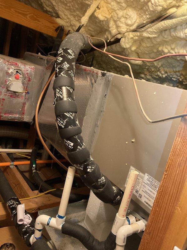 Responded to service call for upstairs HVAC system in 4,216 square foot residence with three separate systems, all approximately two years old and located in attic space. Upstairs unit was running continuously without adequately cooling the designated zones, prompting diagnostic evaluation.

Accessed attic-mounted air handler and associated ductwork through safe and accessible entry point. Performed comprehensive system inspection of upstairs unit, including visual examination of air handler, supply and return ductwork, refrigerant lines, condensate drain system, and electrical connections. Observed spray foam insulation throughout attic space with properly installed reflective duct wrap on main supply trunk lines. Noted copper refrigerant lines with black foam insulation running to outdoor condensing unit, white PVC condensate drain lines with proper trap configuration, and junction box wiring connections.

Evaluated airflow at air handler, checking blower operation and static pressur