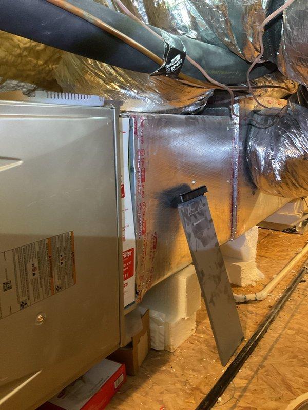 Responded to service call for upstairs HVAC system in 4,216 square foot residence with three separate systems, all approximately two years old and located in attic space. Upstairs unit was running continuously without adequately cooling the designated zones, prompting diagnostic evaluation.

Accessed attic-mounted air handler and associated ductwork through safe and accessible entry point. Performed comprehensive system inspection of upstairs unit, including visual examination of air handler, supply and return ductwork, refrigerant lines, condensate drain system, and electrical connections. Observed spray foam insulation throughout attic space with properly installed reflective duct wrap on main supply trunk lines. Noted copper refrigerant lines with black foam insulation running to outdoor condensing unit, white PVC condensate drain lines with proper trap configuration, and junction box wiring connections.

Evaluated airflow at air handler, checking blower operation and static pressur