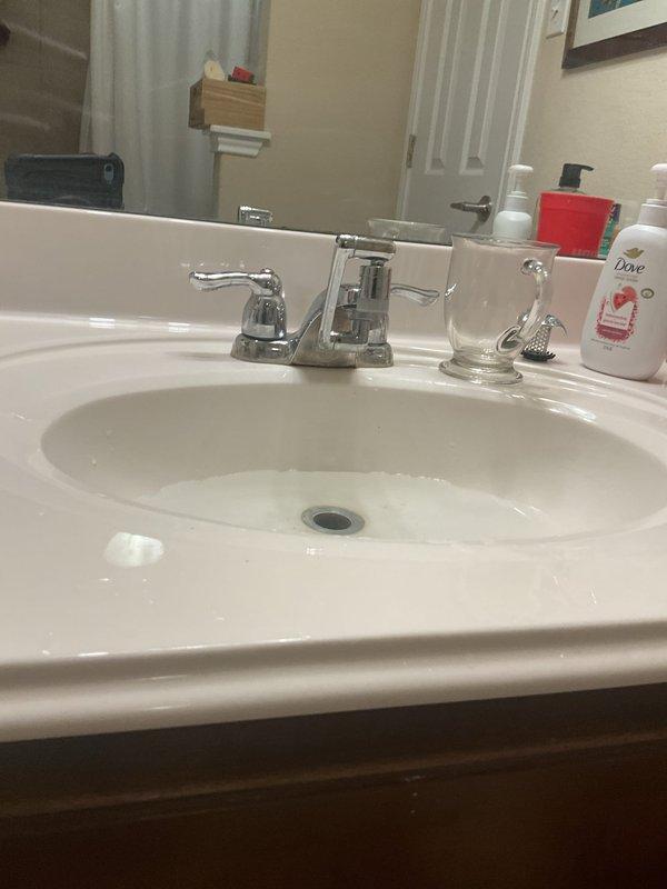 Responded to after-hours service call for sink stoppage in Jack and Jill bathroom. Successfully cleared drain obstruction in bathroom sink using mechanical snake and verified proper drainage flow. Disassembled P-trap assembly to access blockage, removed accumulated debris causing recurring annual stoppage, and reassembled all drain components with proper seals. Inspected remaining toilets throughout home as requested and confirmed all wax ring seals are secure with no signs of leakage or movement. System restored to full operation with no leaks detected upon testing.