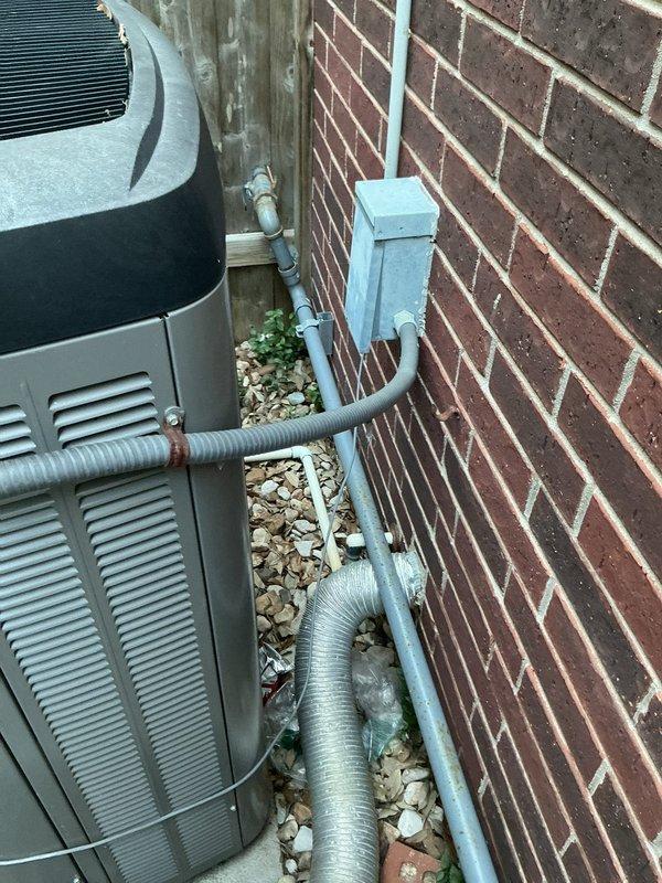 Responded to dual electrical circuit failures affecting AC condenser and kitchen outlets in 1996 residential property. Diagnosed tripped breaker at exterior electrical panel serving condenser unit that would not reset due to fault condition; inspected condenser disconnect, junction box, and associated wiring runs along exterior brick wall. Addressed separate circuit issue affecting non-functioning kitchen outlets on independent branch circuit. Restored power to both affected circuits and verified proper operation of all components.