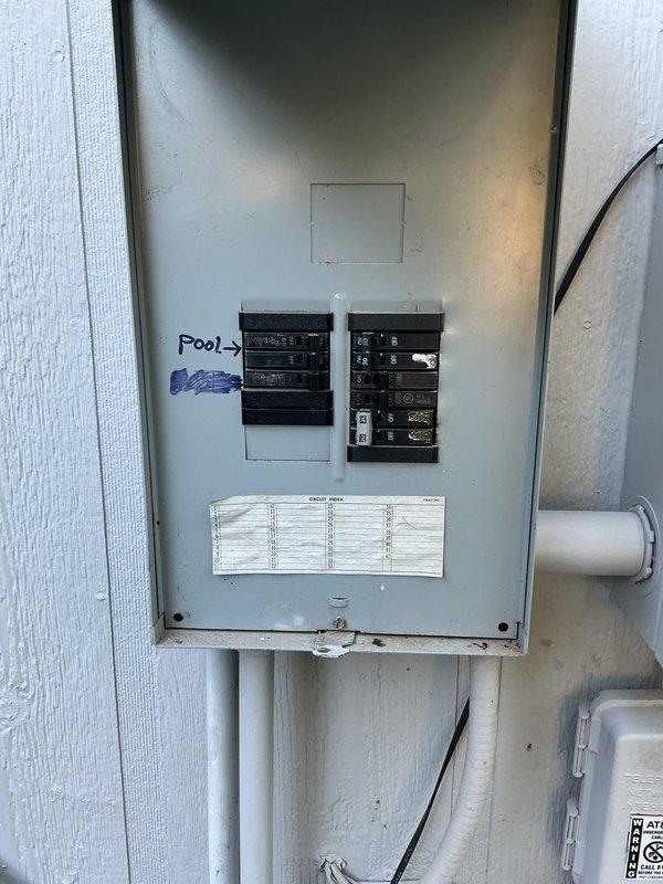 Responded to dual electrical circuit failures affecting AC condenser and kitchen outlets in 1996 residential property. Diagnosed tripped breaker at exterior electrical panel serving condenser unit that would not reset due to fault condition; inspected condenser disconnect, junction box, and associated wiring runs along exterior brick wall. Addressed separate circuit issue affecting non-functioning kitchen outlets on independent branch circuit. Restored power to both affected circuits and verified proper operation of all components.