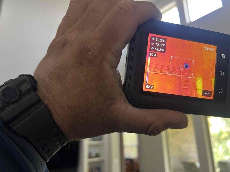 Responded to callback for inadequate airflow to master bedroom. Inspected HVAC system and measured air velocity at supply register using digital anemometer, which confirmed reduced airflow at 12 MPH. Utilized thermal imaging camera to assess temperature distribution throughout the home, identifying significant temperature variance between master bedroom (59.2°F-70.3°F) and other conditioned spaces (79.4°F). Investigation revealed airflow restriction likely caused by damper position, ductwork obstruction, or insufficient supply to affected zone. Documented findings with thermal imagery showing heat loss pattern and airflow measurements at the affected area.