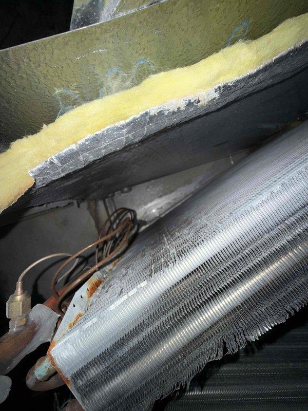 Responded to no cooling complaint on 4-year-old single system. Upon inspection, discovered extensive ice buildup covering the entire evaporator coil surface. Heavy frost accumulation was preventing proper airflow across the coil fins, resulting in loss of cooling capacity. Identified restricted airflow as the primary cause, with filter showing significant debris accumulation and compression. System had received spring maintenance two days prior, indicating rapid development of the freezing condition. Shut down system to allow complete defrost of evaporator coil. Replaced dirty air filter with new filter to restore proper airflow. Verified all refrigerant line insulation intact on copper lines connected to coil assembly. Once coil fully defrosted, restarted system and monitored operation. Confirmed proper airflow restoration and normal cooling cycle resumption. System returned to normal operating parameters with adequate temperature differential across coil.