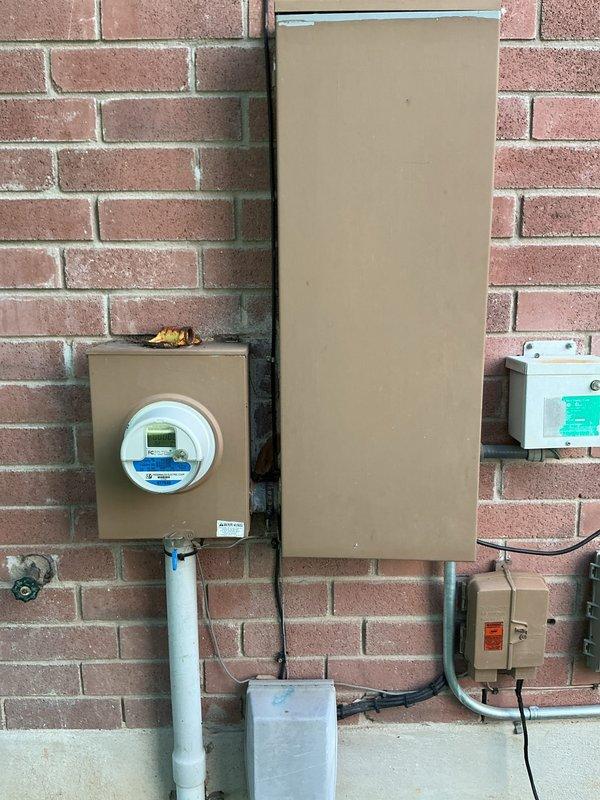 Responded to service call for loose circuit breaker affecting top floor air conditioning system at 31-year-old residential property. Upon arrival, located exterior-mounted electrical panel and conducted thorough inspection of breaker assembly and associated connections. Given previous history of NEMA 14-50 outlet failure and melting incident on same panel, performed comprehensive evaluation beyond the immediate breaker concern.

Inspection revealed loose connection at AC circuit breaker with visible signs of wear on terminals and copper contacts. Examined all wire terminations, including red and black conductors serving the air conditioning unit. Assessed overall panel condition, noting dust accumulation and age-related deterioration of components. Verified proper wire sizing and connection integrity throughout the affected circuit.

Tightened all loose connections at breaker terminals and verified torque specifications per manufacturer requirements. Tested breaker operation and confir