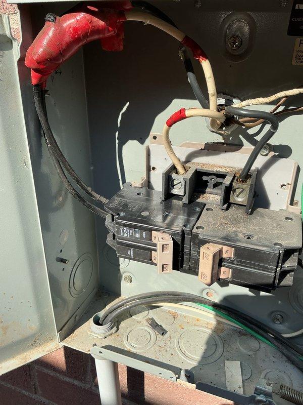 Responded to service call for loose circuit breaker affecting top floor air conditioning system at 31-year-old residential property. Upon arrival, located exterior-mounted electrical panel and conducted thorough inspection of breaker assembly and associated connections. Given previous history of NEMA 14-50 outlet failure and melting incident on same panel, performed comprehensive evaluation beyond the immediate breaker concern.

Inspection revealed loose connection at AC circuit breaker with visible signs of wear on terminals and copper contacts. Examined all wire terminations, including red and black conductors serving the air conditioning unit. Assessed overall panel condition, noting dust accumulation and age-related deterioration of components. Verified proper wire sizing and connection integrity throughout the affected circuit.

Tightened all loose connections at breaker terminals and verified torque specifications per manufacturer requirements. Tested breaker operation and confir