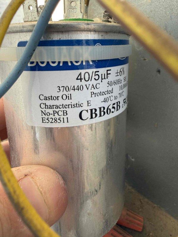 Responded to no-cooling call on 6-year-old HVAC system. Upon inspection, diagnosed failed dual-run capacitor (40/5µF, 370/440 VAC) preventing compressor operation. Replaced defective capacitor with new OEM-equivalent unit and verified proper electrical connections. Measured condenser coil temperature at 97.5°F and confirmed system returned to normal cooling operation with proper refrigerant cycling.