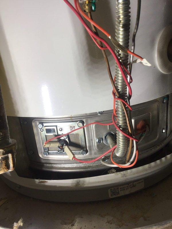 Responded to service call for 40-gallon natural gas tank water heater intermittently shutting off in garage. Unit is approximately 4 years old and had been flushed seven weeks prior without reported issues. Upon arrival, inspected automatic storage water heater and accessed lower control panel area to examine gas control valve, thermocouple, and electrical connections. Verified all wiring connections at junction box were secure and properly routed through flexible metal conduits. Tested thermocouple signal and inspected pilot assembly for proper flame characteristics. Checked gas supply pressure and confirmed proper ventilation. Reviewed manufacturer specifications on unit nameplate indicating natural gas fuel type with 40-gallon nominal capacity. Examined safety controls and thermal cutoff devices for proper operation. Documented unit condition with photographs showing access panel area, internal electrical connections, and manufacturer specification labels for warranty reference give