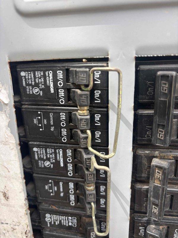 Responded to service call for unlabeled electrical panel serving newer HVAC unit located on left side of property. Performed diagnostic testing using Fluke multimeter to identify correct breaker for the transformer model unit. Successfully traced and verified circuit connections within main electrical panel, measuring voltage readings of 279V during testing process. Documented panel configuration showing multiple circuit breakers with various amperage ratings (40A, 50A) and custom jumper wire connections linking multiple circuits. Identified and confirmed proper breaker assignment for the specified HVAC equipment despite absence of panel labeling, ensuring safe operation and future serviceability of the system.