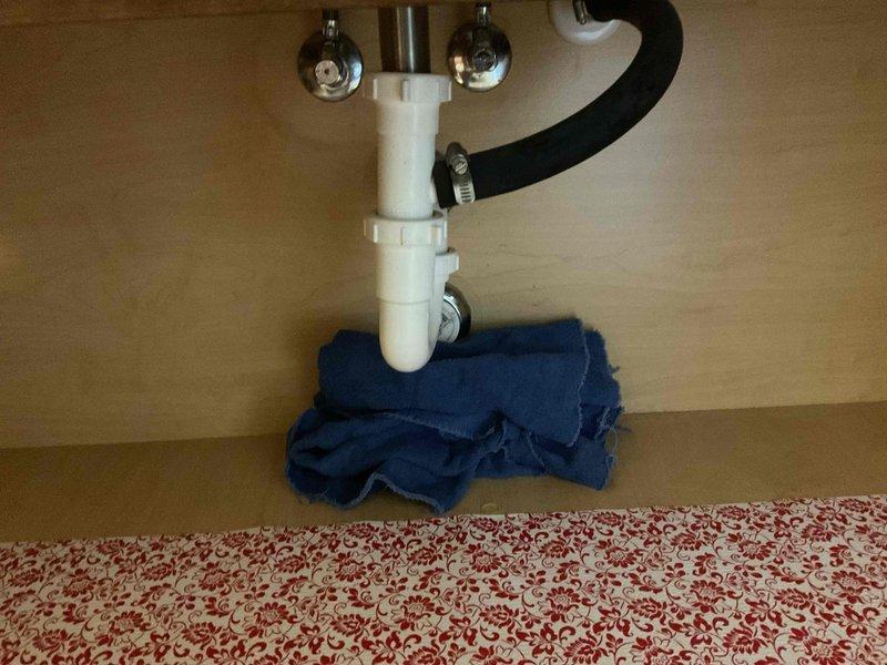 Responded to reported leak at bathroom vanity sink. Upon arrival, performed visual inspection of fixture and supply connections. Accessed cabinet interior and examined PVC drain assembly, P-trap configuration, supply lines, and shut-off valves for signs of active leakage or moisture accumulation. Inspected threaded connections on drain pipe assembly and verified integrity of all compression fittings. Checked chrome-plated faucet supply lines and angle stops for proper seating and tightness. Tested drain stopper mechanism and verified proper operation of brushed nickel faucet assembly with dual handles. No active leak detected at time of inspection; all connections found to be secure and dry. Given property's history of multiple sink-related service calls, advised monitoring the fixture for recurrence and provided recommendations for preventive maintenance.