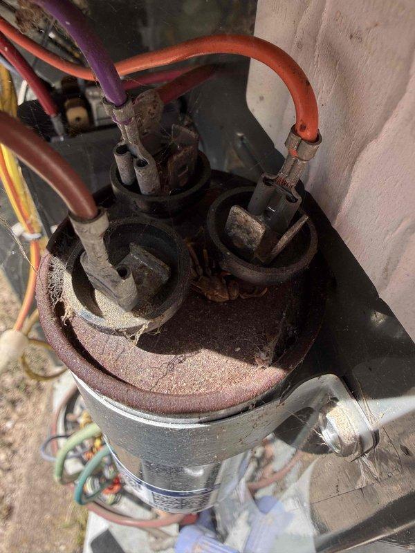 Responded to thermostat replacement request for single HVAC system with split configuration—air handler located in hallway closet and condensing unit positioned in attic. Performed diagnostic evaluation of existing thermostat and system controls to determine functionality and compatibility issues. Inspected outdoor condensing unit, noting advanced corrosion on compressor housing, significant rust deterioration on top panel components, and aging refrigerant line connections with visible mineral deposits and discoloration at valve assemblies. Documented equipment condition showing extensive wear consistent with system of unknown age in 1974 residence. Evaluated system operational parameters and provided recommendations for thermostat upgrade options compatible with existing split system configuration.