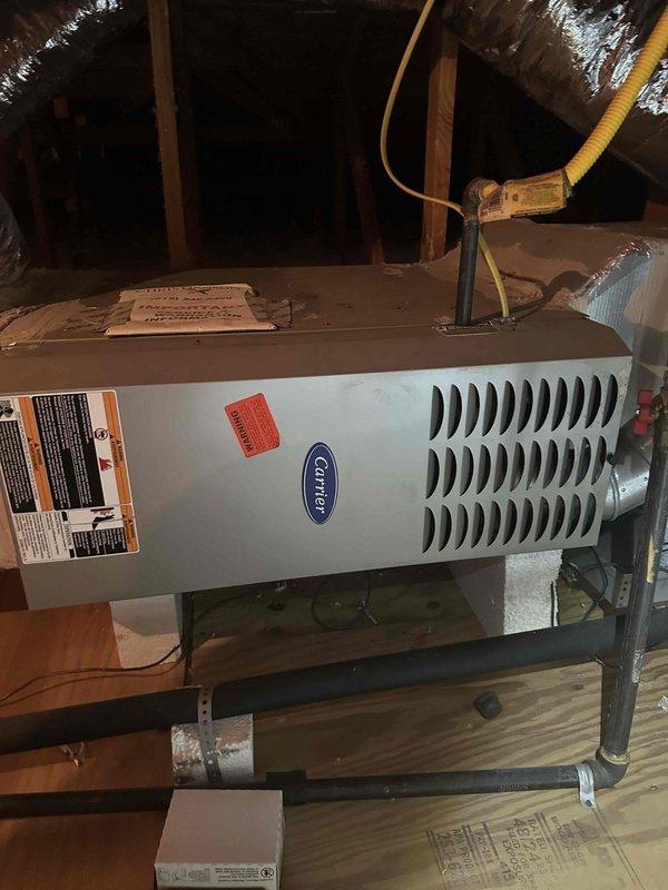 Completed fall maintenance on a 5-year-old Carrier HVAC system located in the attic of a 20-year-old residence. Accessed attic-mounted air handler and performed comprehensive seasonal inspection per manufacturer specifications. Measured and recorded system amperage at 10.43A using calibrated clamp meter, indicating normal operating current draw. Verified voltage readings at 0.0V on secondary circuit during testing sequence. Inspected all accessible ductwork connections and confirmed proper sealing of reflective insulation. Examined condensate drain pan and drainage system for proper function and cleared any debris. Verified all safety labels and manufacturer specifications remain legible on unit exterior. System operating within normal parameters with no immediate service needs identified.