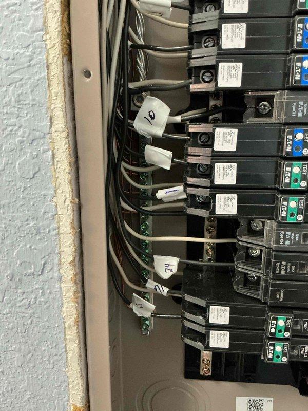 Returned to site to complete finish work on electrical installation. Installed two standard duplex receptacles in bathroom area with proper wall mounting and verified secure connections. Organized and labeled circuit breakers in main electrical panel, attached identification tags to multiple circuits for proper system documentation, and ensured all wiring connections were secure and code-compliant.
