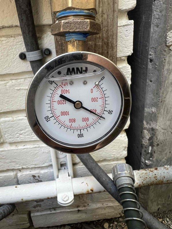Completed return visit to resolve ongoing shower repair issue. Performed comprehensive 30-point plumbing inspection to identify root cause of previous repair failure. Inspected and tested water pressure regulation system, including exterior pressure gauge and associated piping connections. Verified proper water flow and pressure at bathroom fixtures, including sink faucet operation. Documented system conditions with photos showing pressure readings and fixture performance to confirm successful resolution of shower malfunction.