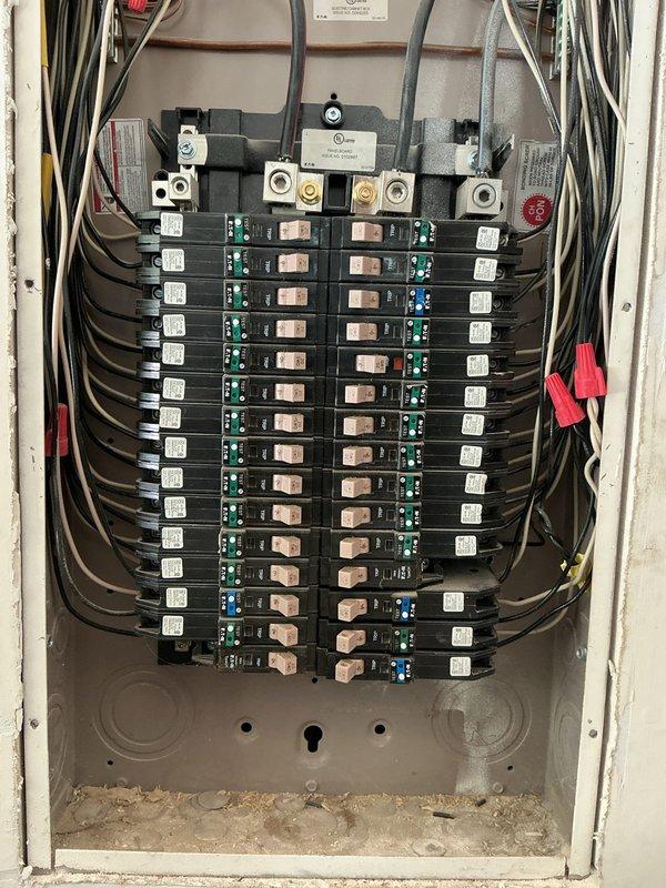 Responded to service call for tripping breakers and GFCI receptacles that would not reset in a 5-year-old residential property. Upon arrival, located and inspected dual electrical panels in utility area. Opened panel covers and performed comprehensive visual inspection of all circuit breakers, bus bars, and electrical connections. Tested affected GFCI circuits and identified fault conditions preventing proper reset function. Inspected breaker integrity, verified proper seating of all breakers in panel, and checked for signs of overheating or loose connections at terminals. Examined neutral and ground bus bar connections for proper torque and wire integrity. Documented panel conditions with photographs showing breaker arrangement, wiring configuration, and overall system status for customer records.