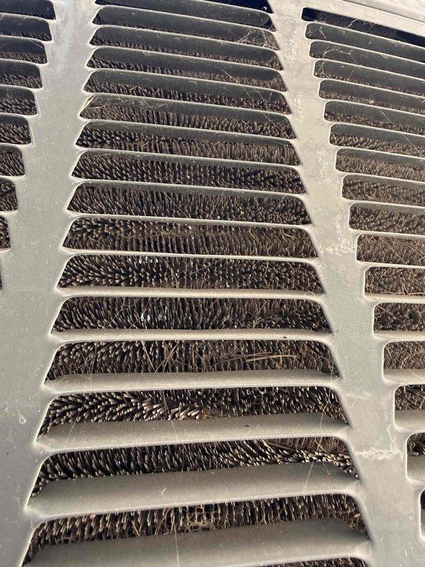 Responded to service call for upstairs HVAC unit in 3,491 square foot residence with dual attic-mounted systems, both approximately 8 years old. Unit was running continuously but failing to maintain temperature below 80°F. Upon inspection, discovered evaporator coil heavily contaminated with dust and debris buildup, significantly restricting airflow and reducing heat transfer efficiency. Measured system performance using digital diagnostic equipment to confirm reduced cooling capacity. The excessive accumulation on the coil fins was preventing proper refrigerant heat exchange, causing the system to run continuously without achieving setpoint temperature. Documented conditions with photos showing extent of contamination on heat exchanger surfaces and insulated ductwork components.