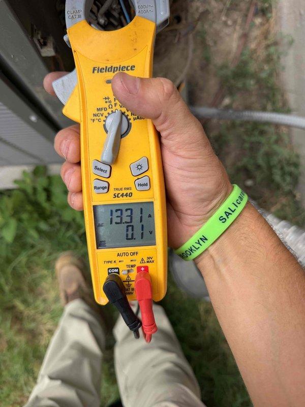 Performed comprehensive maintenance service on 9-year-old HVAC system located in attic accessed via second-floor pulldown ladder. System had not received maintenance in 6 years and was experiencing reduced cooling capacity on hot days with increased energy consumption. Inspected and cleaned air handler components including blower wheel assembly, verified proper airflow through ventilation system, and tested electrical performance using clamp meter which indicated operating current of 133.1 amps. Addressed hot and cold spot issues throughout 3,265 square foot residence by evaluating system performance and airflow distribution to restore optimal cooling efficiency.