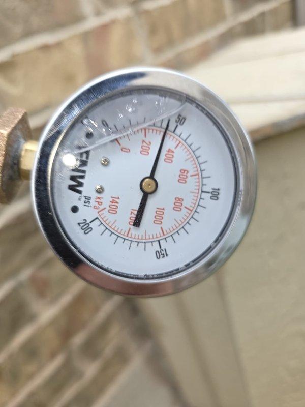 Completed routine maintenance flush on a 5-year-old residential water heater installed in attic space. Verified proper operation of pressure relief valve, inspected expansion tank mounting and connections, and confirmed system pressure readings within normal operating range. All components found to be functioning correctly with no leaks detected.
