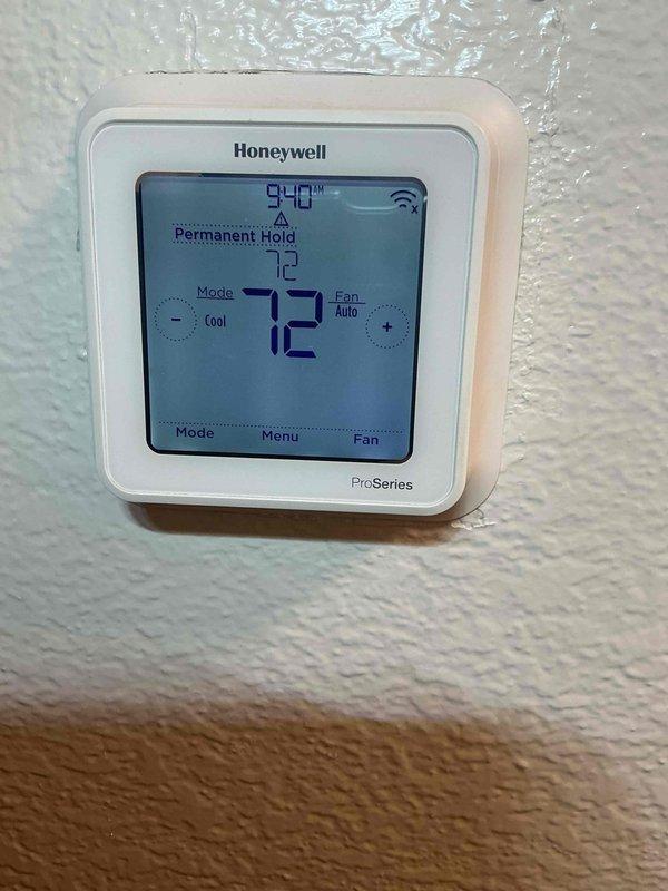 Completed routine member maintenance on a 7-year-old Lennox HVAC system located in interior closet. Verified system cooling operation with thermostat set to 72°F in cooling mode with auto fan setting, confirmed 16-degree temperature split across evaporator coil (75.2°F return air minus 59.2°F supply air indicates proper refrigerant charge and heat transfer). System operating within normal parameters with no immediate service needs identified.