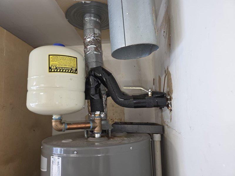 Completed comprehensive plumbing maintenance inspection on a 26-year-old residential property with a gas-fired tank-style water heater located in the garage. Performed visual inspection of the water heater unit, expansion tank, and associated plumbing connections, including copper supply lines, brass fittings, and flexible gas connector. Verified proper installation of expansion tank with pressure relief components and assessed condition of all visible piping, insulation wrapping, and mechanical connections. Inspected plumbing fixtures throughout the property, including sink drains and stoppers for proper operation and drainage performance.