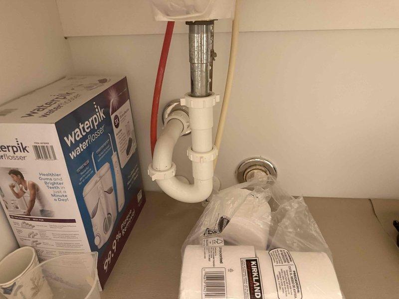 Responded to guest bathroom sink stoppage at 20-year-old residential property. Accessed plumbing assembly beneath vanity and cleared obstruction from P-trap and drain line, restoring full drainage function. Verified proper water flow and confirmed no leaks at trap connections upon completion.