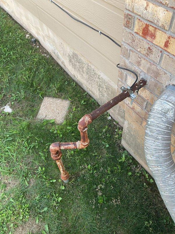 Installed gas line hookup with quick-disconnect fitting for portable generator at exterior of residence. Connected copper gas piping from existing supply to outdoor generator connection point, completing the fuel supply portion of the generator installation project coordinated with electrical and HVAC trades.