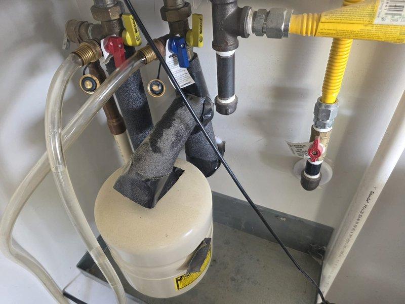 Completed comprehensive plumbing maintenance on 4-year-old gas tankless water heater system located in garage. Inspected all water supply connections, gas line connections with shut-off valve, exhaust venting, condensate drain line, and expansion tank for proper operation and safety compliance. Verified all pipe fittings, flexible gas line, and pump assembly connections are secure with no signs of leaks or corrosion, and confirmed system is operating within manufacturer specifications.