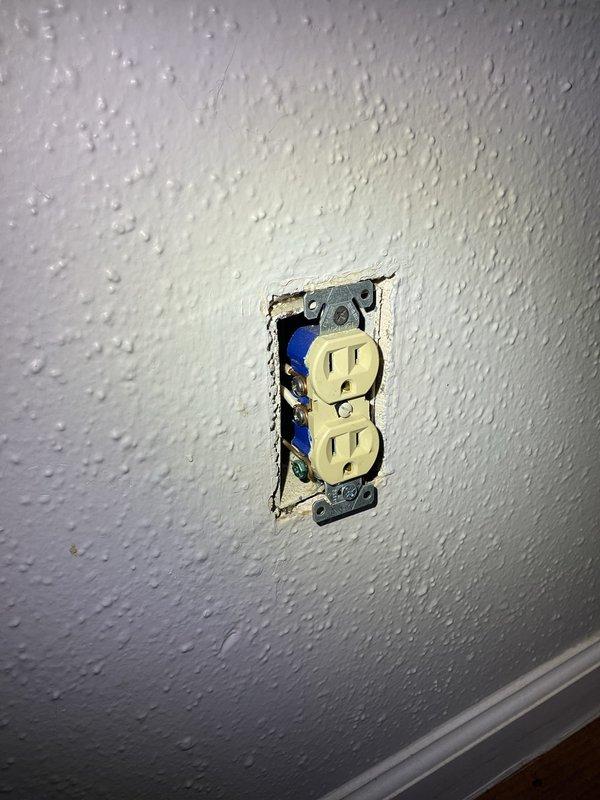 Responded to service call for outlet replacement and installation in residential property. Upon arrival, performed electrical safety testing using digital multimeter to verify circuit integrity and proper grounding. Removed existing defective duplex receptacle from wall-mounted electrical box, inspecting visible wiring and connections for code compliance and damage. Replaced two worn outlets with new beige duplex receptacles, ensuring proper wire termination to brass and silver terminal screws and secure ground connection. Installed one additional outlet as requested, verifying proper wire gauge and circuit capacity. Tested all receptacles under load to confirm correct polarity, grounding, and functionality. Secured devices to electrical boxes with appropriate mounting hardware and reinstalled cover plates. All work performed in accordance with current NEC standards.
