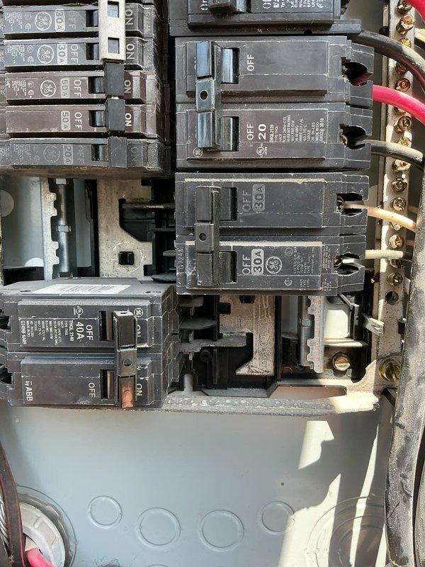 Responded to service call regarding crackling noise heard from light switch panel after bulb replacement. Performed comprehensive whole-home electrical inspection on 19-year-old residential property equipped with two breaker boxes located in garage and exterior. Conducted thorough tune-up and safety inspection of both General Electric breaker panels, verifying proper toggle switch operation, circuit breaker integrity, and secure wire terminations at bus bars and terminal screws. Inspected all visible wiring connections, checked for signs of arcing, overheating, or loose connections that could produce audible crackling sounds. Verified proper amperage ratings across all circuits and confirmed breakers were properly seated on mounting rails. Examined exterior electrical meter enclosure and dual power source system with solar photovoltaic energy storage integration. All breaker box components found to be in serviceable condition with no immediate safety hazards identified. Completed routi