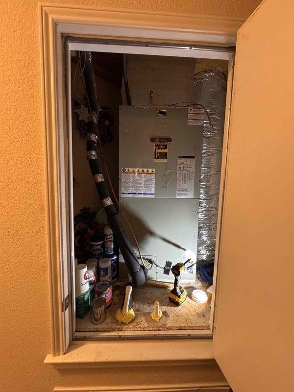 Responded to service call for non-operational HVAC system with reported water leak. Upon arrival, accessed air handler unit located in interior utility closet of 18-year-old residence. Performed diagnostic inspection of air handler assembly, examined condensate drainage system, and verified refrigerant line connections for leak sources. Measured temperature differential across supply vents using calibrated digital thermometer to assess system performance. Identified source of water intrusion and completed necessary repairs to restore unit to proper working condition. System tested and confirmed operational upon departure.