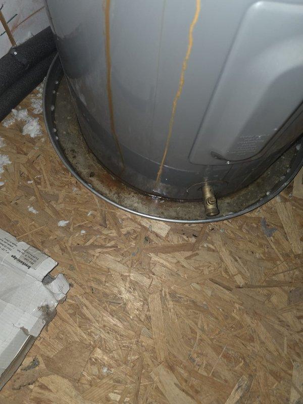 Responded to no hot water complaint at residential property. Upon inspection, found existing Rheem Classic series water heater exhibiting significant rust staining and corrosion at top connections, with visible moisture damage on surrounding floor indicating active leak at tank fittings. Assessed unit condition and determined water heater required replacement due to compromised tank integrity and failed connections. Installed new water heater unit, connected all necessary water supply lines and gas connections per manufacturer specifications and local code requirements, and verified proper operation with full system testing.
