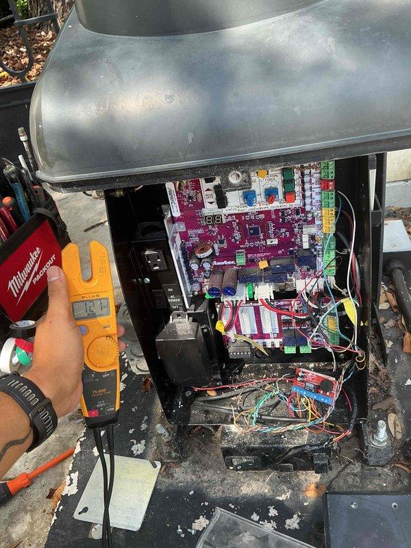 Responded to no power condition at walkway gate magnetic lock. Performed voltage testing and diagnostic inspection of gate control panel and associated electrical components. Utilized digital multimeter to verify power supply, circuit integrity, and control board functionality. Inspected magenta control board, relay connections, terminal blocks, and wiring harness for loose connections, damaged components, or signs of environmental exposure. Assessed condition of internal panel components including circuit protection devices and identified debris accumulation at panel base. Verified proper grounding and connection integrity throughout control system to restore power to magnetic lock mechanism.