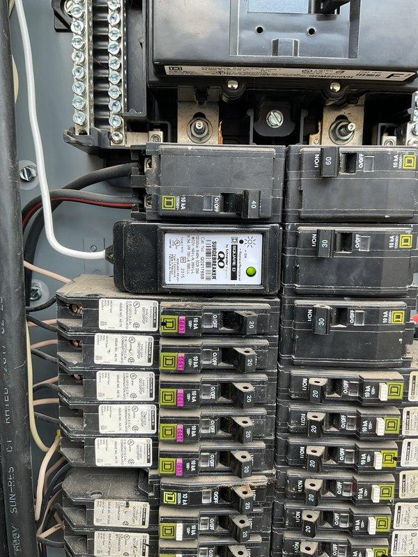 Removed existing surge protection device from main electrical panel and properly sealed the knockout hole at the bottom of the enclosure. Installed a new secondary breaker-style surge protector in the main distribution panel and connected the neutral wire to the appropriate grounding bar, ensuring proper whole-house surge protection with 5-year warranty coverage.