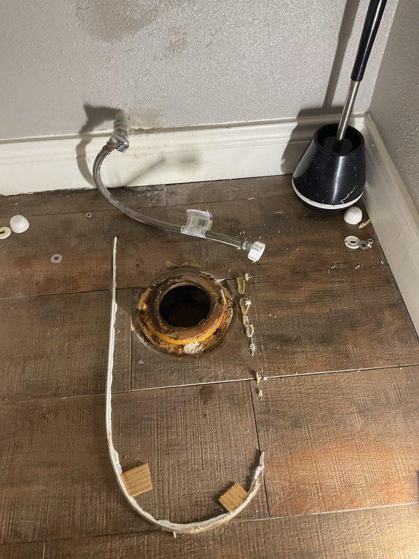 Responded to complaint of sewer gas odor in master bathroom. Upon investigation, removed toilet to access closet flange and identified source of odor. Found toilet flange exhibiting heavy rust and corrosion with deteriorated seal integrity. Removed toilet, documented corroded flange condition, and prepared area for flange replacement to eliminate sewer gas infiltration into living space.
