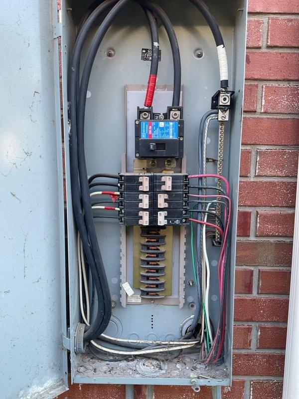 Responded to intermittent power loss affecting primary bedroom circuit that was losing power every three hours, with partial lighting failure in the room. Inspected main electrical service panel and subpanel serving affected bedroom circuits. Found bedroom circuit improperly shared with secondary bedroom on 20-year-old original wiring system. Traced circuit routing and identified overloaded breaker causing nuisance tripping due to cumulative load from both bedrooms on single circuit. Panel inspection revealed aged components with visible wear, dust accumulation, and service entrance cables showing signs of long-term use in 2006-built residence. Documented main panel configuration including 220V circuits for AC units, pool equipment, and dryer, along with subpanel distribution. Identified circuit labeling and verified solar system integration with proper caution markings. Resolved intermittent power issue by redistributing bedroom loads to separate dedicated circuits, ensuring each bedr