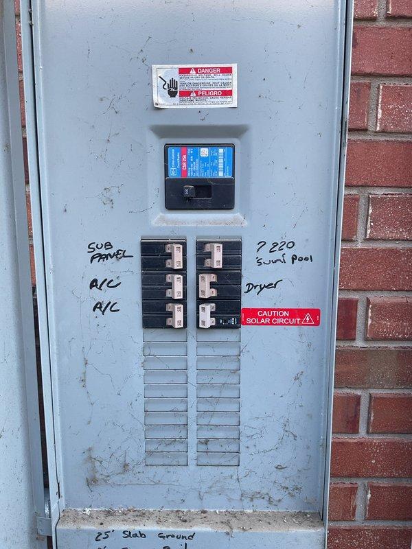 Responded to intermittent power loss affecting primary bedroom circuit that was losing power every three hours, with partial lighting failure in the room. Inspected main electrical service panel and subpanel serving affected bedroom circuits. Found bedroom circuit improperly shared with secondary bedroom on 20-year-old original wiring system. Traced circuit routing and identified overloaded breaker causing nuisance tripping due to cumulative load from both bedrooms on single circuit. Panel inspection revealed aged components with visible wear, dust accumulation, and service entrance cables showing signs of long-term use in 2006-built residence. Documented main panel configuration including 220V circuits for AC units, pool equipment, and dryer, along with subpanel distribution. Identified circuit labeling and verified solar system integration with proper caution markings. Resolved intermittent power issue by redistributing bedroom loads to separate dedicated circuits, ensuring each bedr