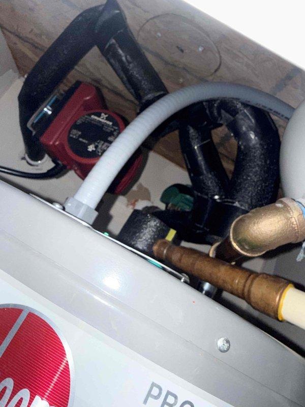 Completed comprehensive plumbing member maintenance on a 2-year-old electric tank water heater located in the garage. Performed full system inspection including visual assessment of tank condition, pipe connections, and circulation pump operation. Verified proper functioning of all plumbing components, checked temperature and pressure relief valve, inspected anode rod condition, and examined all supply and discharge piping for signs of corrosion or leaks. Evaluated hot water recirculation system with red circulation pump and associated black piping assembly. Confirmed adequate clearance around unit and proper venting configuration. All components found to be operating within normal parameters with no immediate service needs identified at time of inspection.