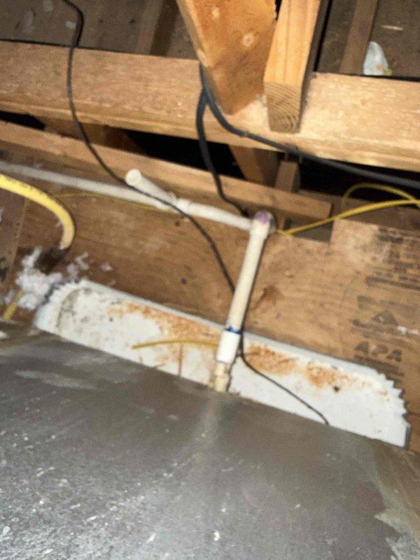 Responded to service call for non-operational HVAC system in 1986 residence. Upon inspection, discovered primary condensate drain line was completely clogged, causing water backup that triggered the safety float switch and shut down the system. Cleared blockage from drain line, verified proper drainage flow, and reset safety switch. System restored to normal operation with all components functioning properly.