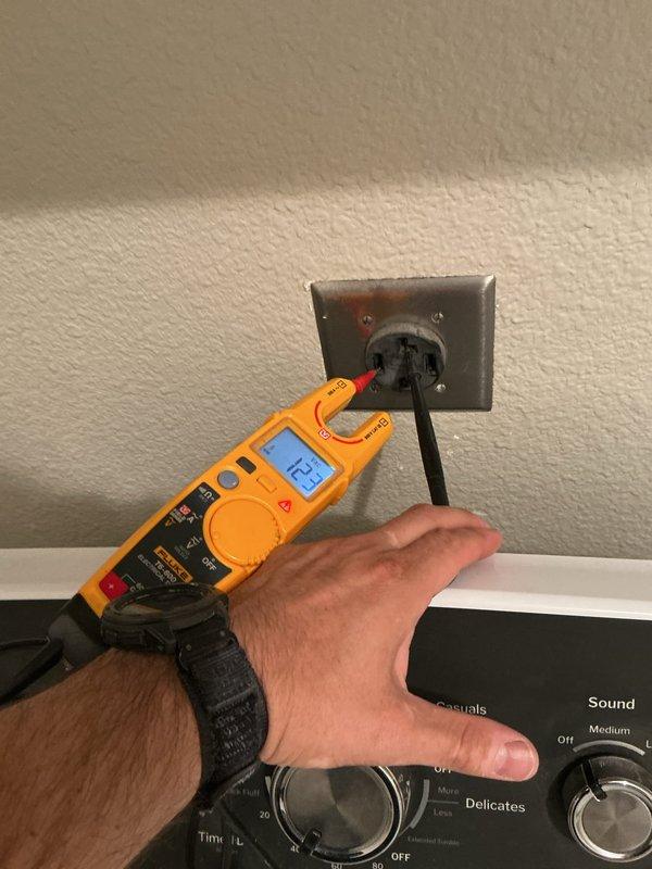 Responded to no-power complaint on electric dryer circuit following referral from appliance repair technician. Upon arrival, verified dryer outlet was not delivering proper voltage using calibrated Fluke multimeter. Tested receptacle under load and confirmed absence of 240V supply to dryer location. Traced circuit back to main electrical panel and identified tripped breaker on dedicated dryer circuit. Inspected breaker for signs of failure, overheating, or damage. Reset breaker and verified restoration of proper voltage at dryer receptacle, measuring 240V across both hot legs. Cycled dryer to confirm operational power supply and proper circuit function. Performed visual inspection of 20-year-old electrical panel for any additional concerns including signs of corrosion, loose connections, or outdated components. All testing confirmed circuit integrity restored and dryer receiving appropriate power for normal operation.