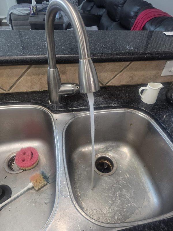 Responded to callback for low water pressure at kitchen sink following recent AquaPure whole-house filter cartridge replacement. Upon arrival, verified reduced flow at kitchen faucet and traced issue to filter housing assembly. Inspected filter installation, found cartridge improperly seated within housing causing partial obstruction to water flow. Shut off main water supply, depressurized system, and opened filter canister. Removed and properly reinstalled filter cartridge, ensuring correct alignment and full seating within housing. Verified O-ring seal integrity and proper threading of canister. Restored water supply and purged air from lines. Tested flow rate at kitchen faucet and confirmed full water pressure restoration to normal operating levels. Checked for leaks at filter housing and connections—all secure with no drips detected. Advised homeowner on proper filter maintenance intervals and signs of flow restriction.