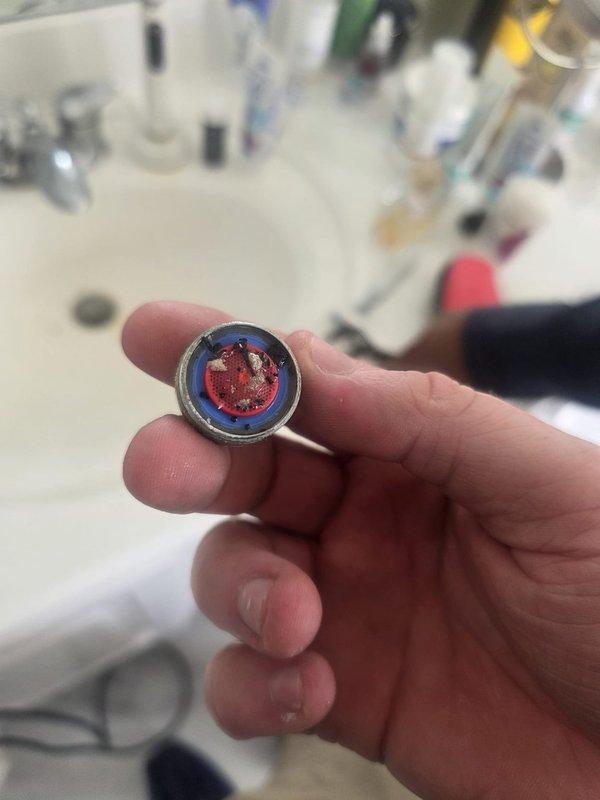 Responded to callback for low water pressure at kitchen sink following recent AquaPure whole-house filter cartridge replacement. Upon arrival, verified reduced flow at kitchen faucet and traced issue to filter housing assembly. Inspected filter installation, found cartridge improperly seated within housing causing partial obstruction to water flow. Shut off main water supply, depressurized system, and opened filter canister. Removed and properly reinstalled filter cartridge, ensuring correct alignment and full seating within housing. Verified O-ring seal integrity and proper threading of canister. Restored water supply and purged air from lines. Tested flow rate at kitchen faucet and confirmed full water pressure restoration to normal operating levels. Checked for leaks at filter housing and connections—all secure with no drips detected. Advised homeowner on proper filter maintenance intervals and signs of flow restriction.
