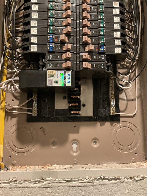 Responded to service call for recurring breaker trips affecting garbage disposal and washer/laundry room circuits in 2020-built residence. Performed comprehensive diagnostic evaluation of electrical panel and affected branch circuits. Inspected main service panel, verified proper breaker sizing, examined bus bar connections, and tested circuit integrity using digital metering equipment. Assessed load distribution across affected circuits to identify potential overload conditions or wiring faults. Documented panel configuration and circuit breaker arrangement with photographic evidence showing internal wiring organization, breaker positions, and main disconnect assembly. Evaluated exterior meter installation and service entrance conductors for any upstream issues that could contribute to nuisance tripping. Identified specific circuit requiring attention and provided technical findings to customer regarding the root cause of breaker trips on garbage disposal and laundry room circuits.